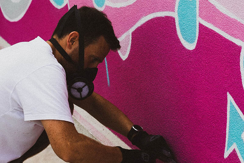 Spray painter working on wall mural | McAuliffe Painting