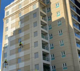 Painters abseiling down apartment building | McAuliffe Painting