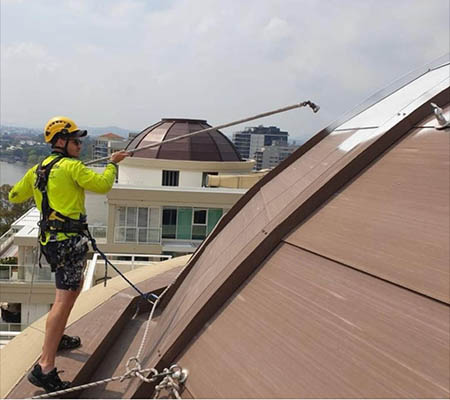 Painter on roof painting building dome | McAuliffe Painting