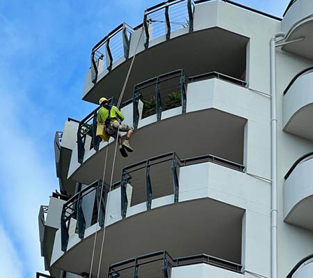 Painters abseiling down apartment building balconies | McAuliffe Painting