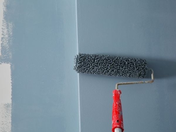 Roller painting wall grey